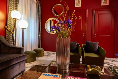 a living room with a vase of flowers on a table at Boutique Hotel Metro 900 in Naples