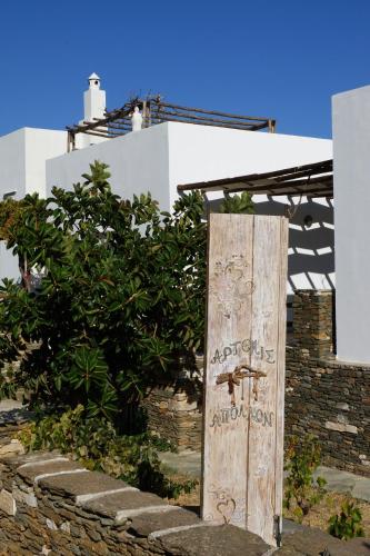 a wooden door with writing on it in front of a building at Apollon-Artemis Apartments in Apollonia