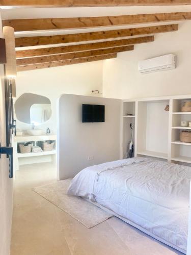 a bedroom with a bed and a tv on the wall at Casa Marítima in Altea