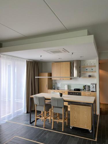 a kitchen with a table and chairs in a room at Stylish Sea-View Apartment by the Marina in Kuressaare