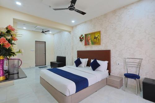 a bedroom with a large bed in a room at Hotel Lord Krishna Dham in Dwarka