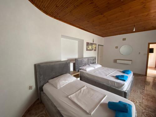 a room with three beds in a room at Vila Demiraj Ksamil Sarande in Ksamil