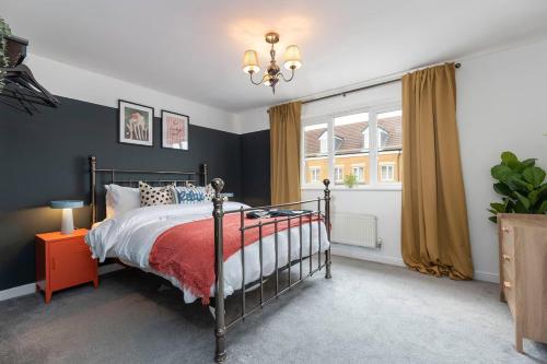 a bedroom with a bed with a red blanket at Stylish Durham 3-Bed Comfort Long Stays in Spennymoor