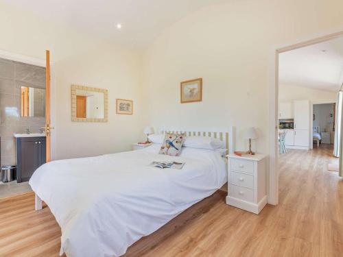 a white bedroom with a white bed and a mirror at 2 Bed in Winchester oc-77384 in Owslebury