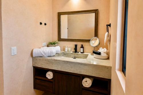 a bathroom with a sink and a mirror at Simple Stay, Big Views, Private Room & Pool in Todos Santos