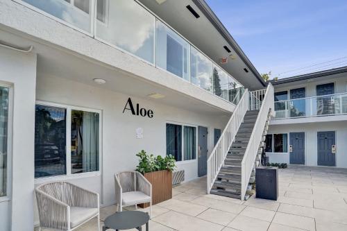 a building with a staircase and chairs in front of it at King Suite at Ocean Blvd in Fort Lauderdale