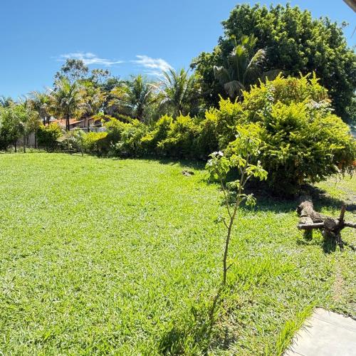 a park with a bench sitting in the grass at Chacara Italia in Uberaba