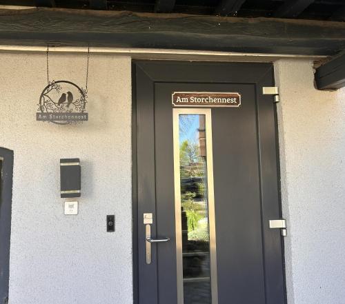 a door of a building with a sign above it at Am kleinen Storchennest in Ummendorf