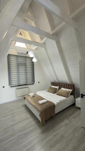 a bedroom with a large bed in a attic at Gabala A frame Guest villa in Gabala