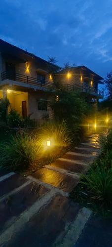 a house lit up at night with street lights at The Kiran's Resort Pench in Khawāsa