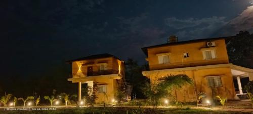 a building with lights in front of it at night at The Kiran's Resort Pench in Khawāsa