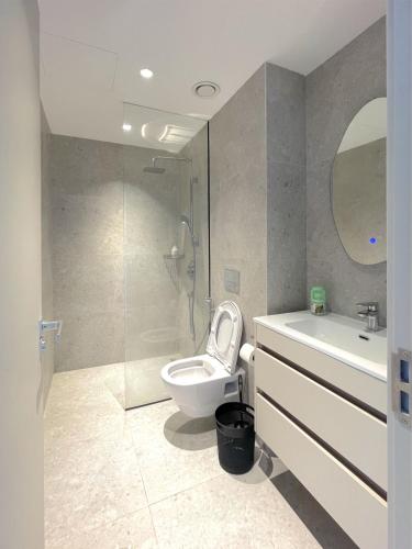 a bathroom with a toilet and a sink and a shower at Nyali Evoque - BriSta Stays in Mombasa