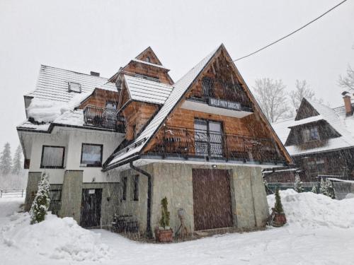 a house is covered in snow at Willa Przy Skoczni in Zakopane