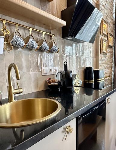 a kitchen with a sink and a counter top at Avra Guesthouse in Limenas