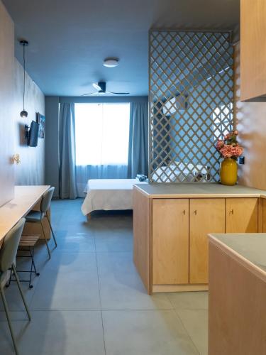 a room with a bedroom with a bed and a kitchen at Downtown photographer's studio 2 in Korinthos