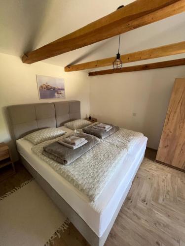 a bedroom with a large bed in a room at Apartman River in Belišće