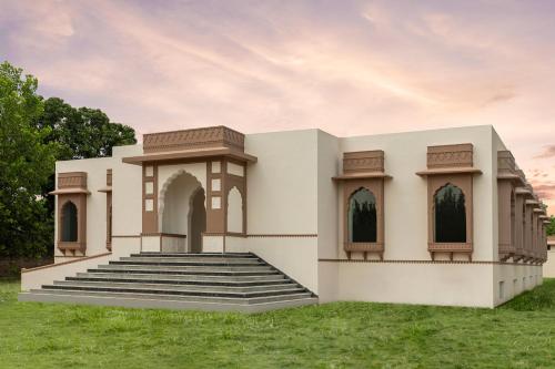 a building in a field with grass at ZANA Luxury Forest Resort, Ranthambore in Sawāi Mādhopur