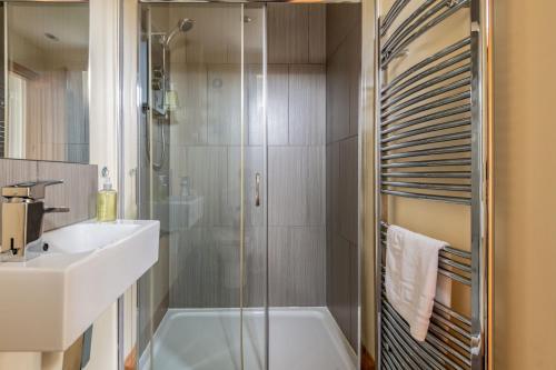 a bathroom with a tub and a sink and a shower at Dreelside - No 50 in Anstruther