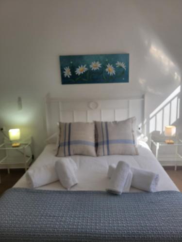a bedroom with a large white bed with pillows at Casa Rural El Pinar de Jesus in Arcos de la Frontera