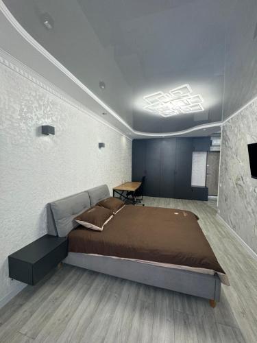 a bedroom with a bed and a table in it at ЖК Акварель 2 in Odesa