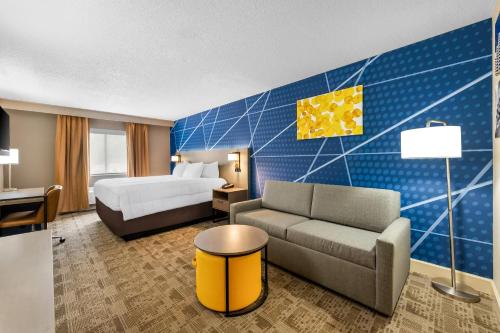 a hotel room with a bed and a couch at Comfort Inn Pikeville in Pikeville