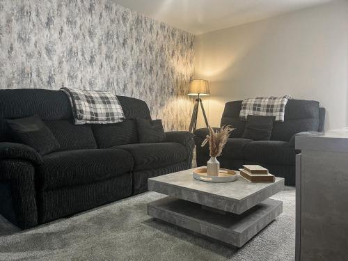 a living room with a couch and a coffee table at Spring Gardens in Lower Darwen