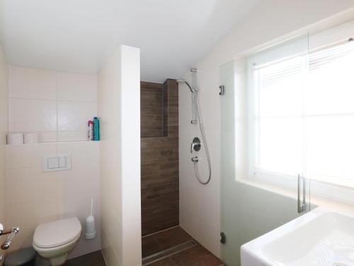 a bathroom with a shower and a toilet and a sink at Vacation home in Flachau in Flachau