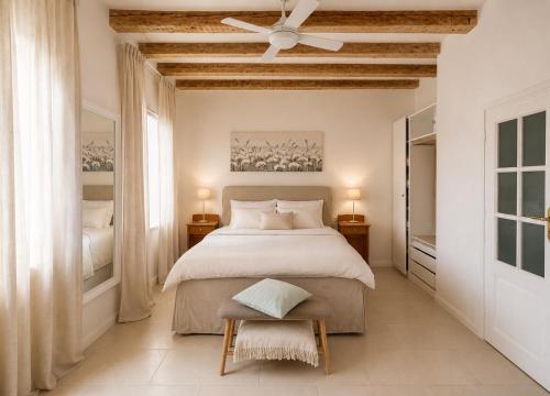 a bedroom with a bed and a ceiling fan at Cotton House Pool & Garden in Novi Vinodolski