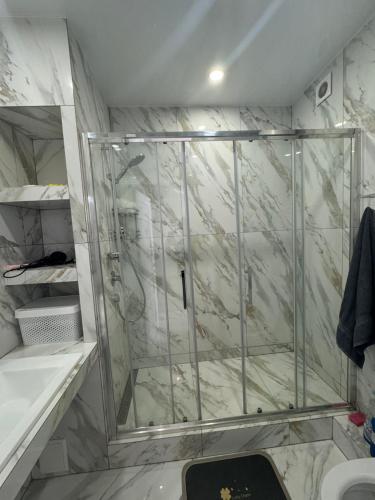 a shower with a glass door in a bathroom at ЖК Акварель 2 in Odesa