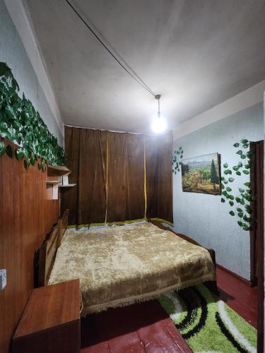 a bedroom with a large bed in the corner at Live as you are LOCAL in Tbilisi City