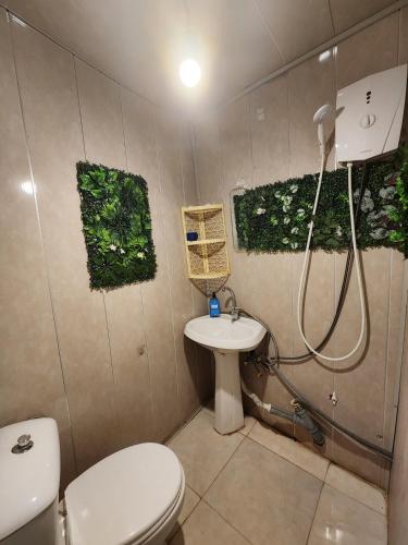 a bathroom with a toilet and a shower and a sink at Live as you are LOCAL in Tbilisi City