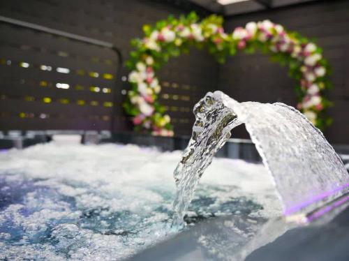 a water fountain on top of a pool of snow at Luxehaus MCR in Manchester