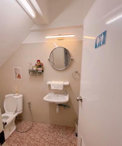 a bathroom with a sink and a toilet and a mirror at latitude 14 Room & breakfast in Ban Bang Sakae
