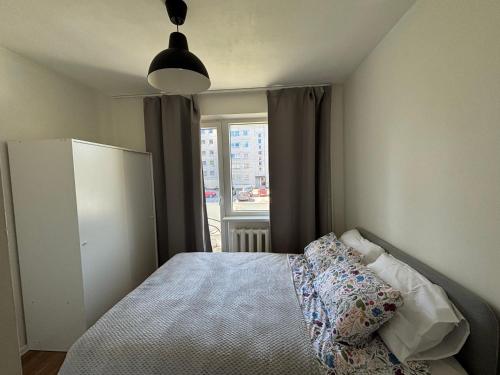 a small bedroom with a bed and a window at Green & Quiet Apartment in Haapsalu in Haapsalu