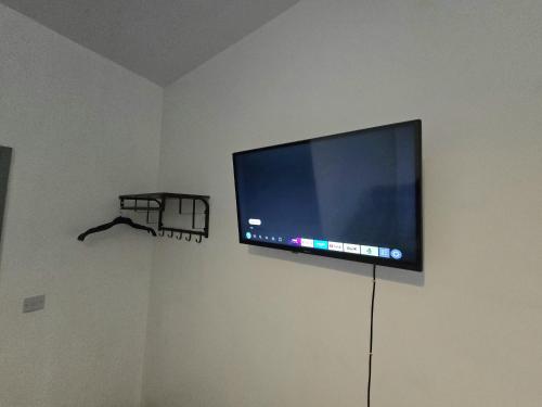 a flat screen tv hanging on a wall at Church Views in Burnley