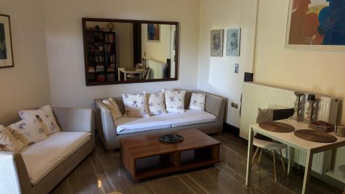 a living room with a couch and a table at Elis studio luxury apartment in Ierapetra