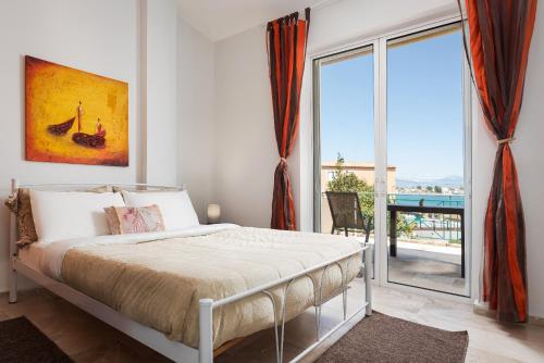 a bedroom with a bed and a large window at Megusta Apartments Selianitika - Poolside Escape in Selianitika