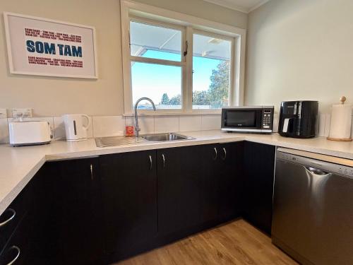 a kitchen with a sink and a microwave at Hanmer Time in Hanmer Springs