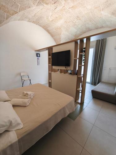 a bedroom with a bed and a tv in a room at Casa Gentile in Conversano