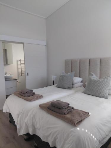 a bedroom with a large white bed with towels on it at Superb accommodation in Stilbaai in Stilbaai