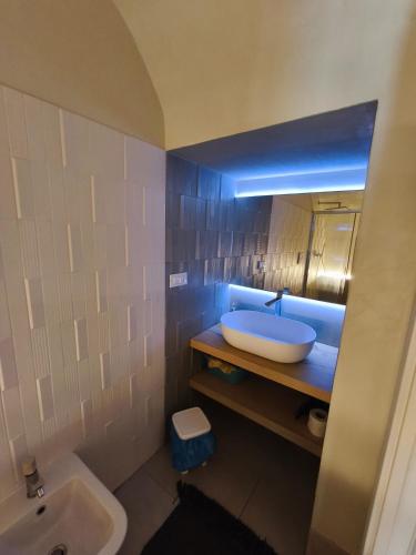 a bathroom with a sink and a bath tub at Casa Gentile in Conversano
