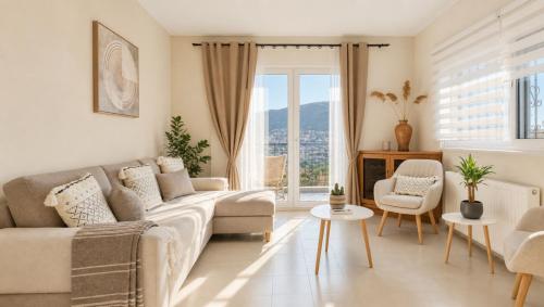 a living room with a couch and a large window at Villa Aelia Luxury Maisonette in Salamina