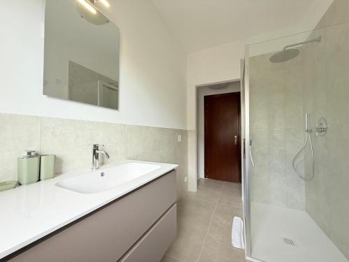 a white bathroom with a sink and a shower at SE148 - Marotta, trilocale con terrazzo e posto auto in Marotta