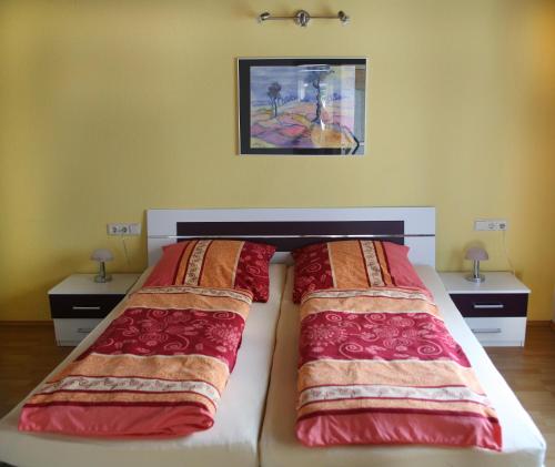 a bedroom with two beds and two night stands at Ferienwohnung Neuber in Bad Kissingen