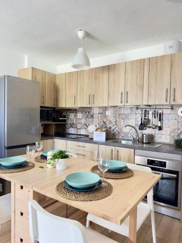 a kitchen with a wooden table with blue plates on it at NextGen Casa Rossy in Antigua