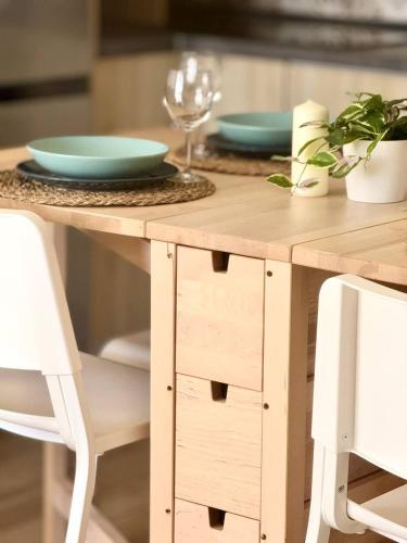 a wooden table with two plates on top of it at NextGen Casa Rossy in Antigua