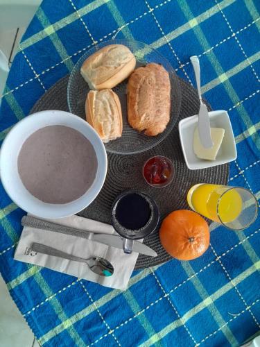 a table with a plate of bread and a bowl of soup at Résidence Belle Place Palmier in Saint-François