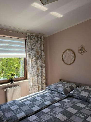 a bedroom with a bed and a window at Apartament Marco z balkonem in Oleśnica