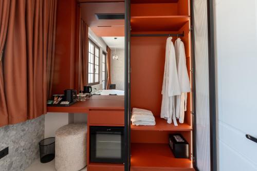 a bathroom with orange walls and a sink at Art Boutique Hotel Berat in Berat