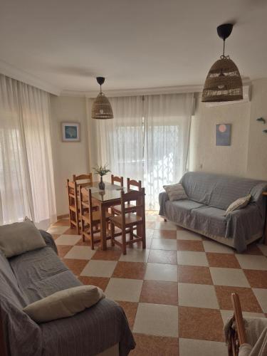 a living room with a couch and a table at Casa Delfin in Punta Umbría